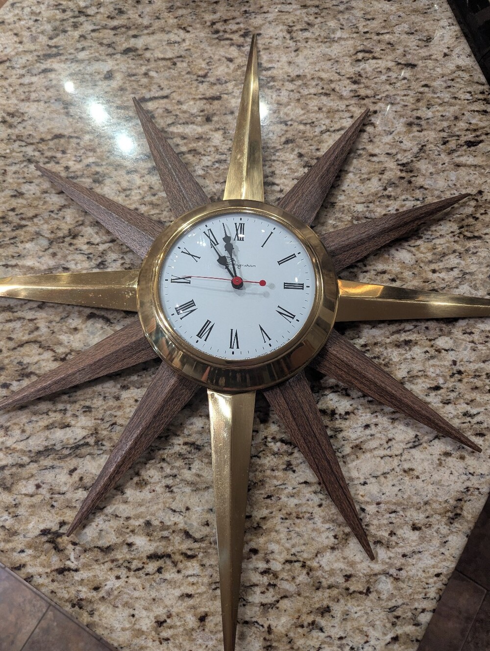 Mid century Modern electric starburst clock by Ingraham gold &  Wood Grain Metal